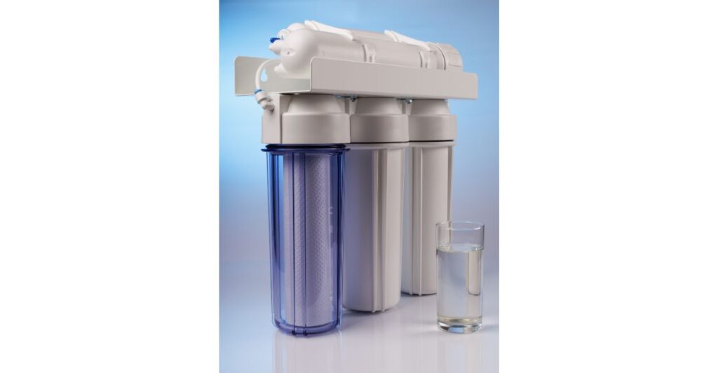 Refil de filtro de purificador de água ao lado de um copo com água limpa